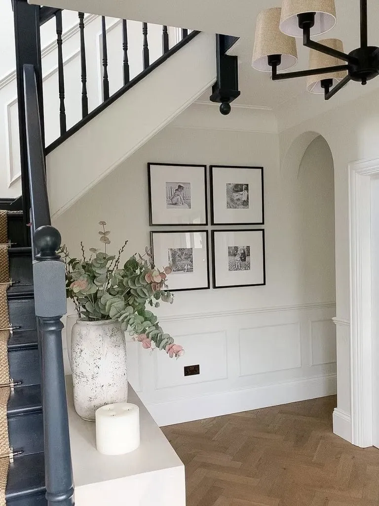 White hallway with black bannister