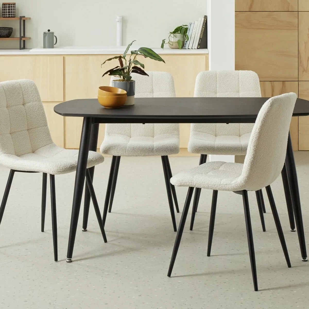 Black rectangular dining table with tapered legs