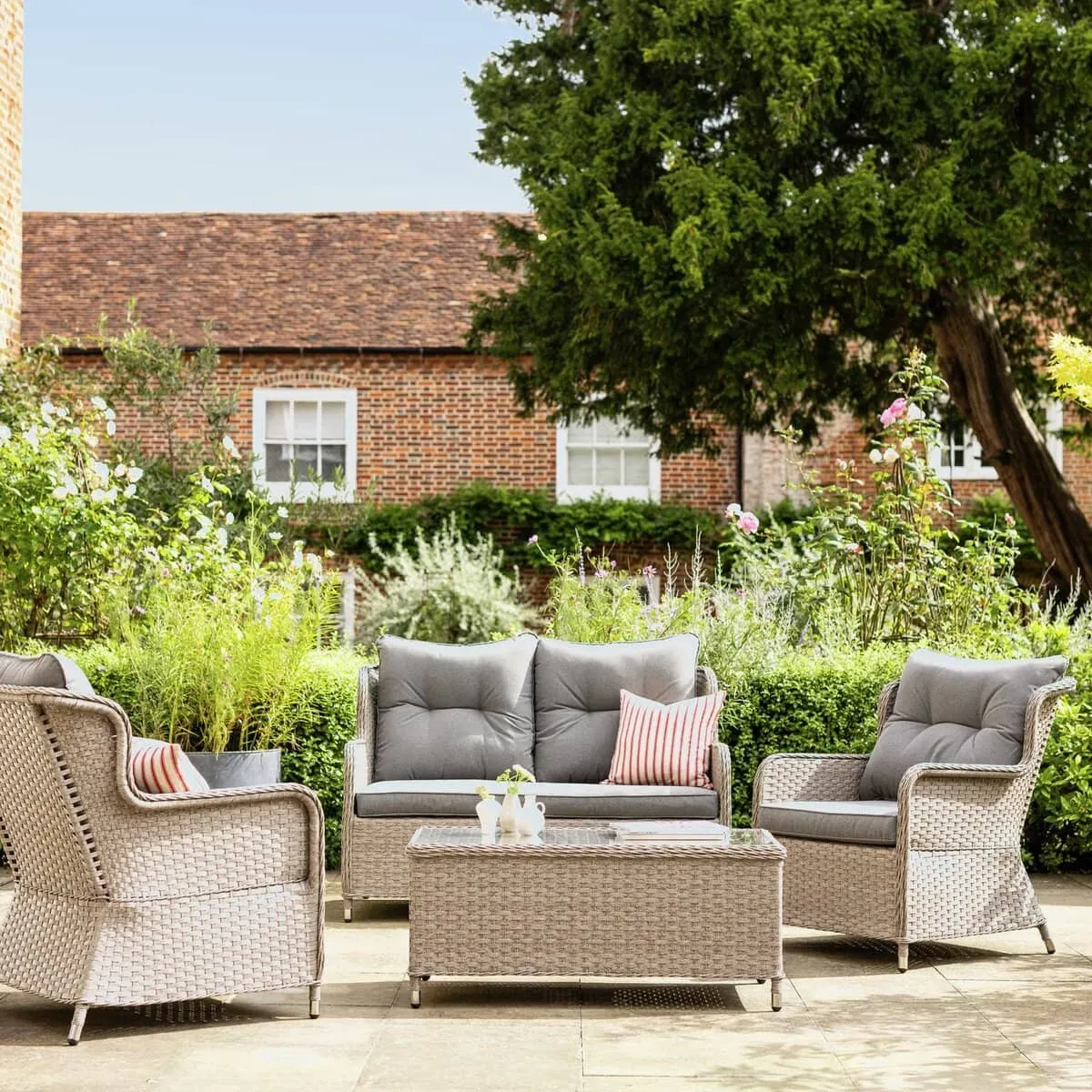 Rattan sofa and two armchairs with a matching coffee table