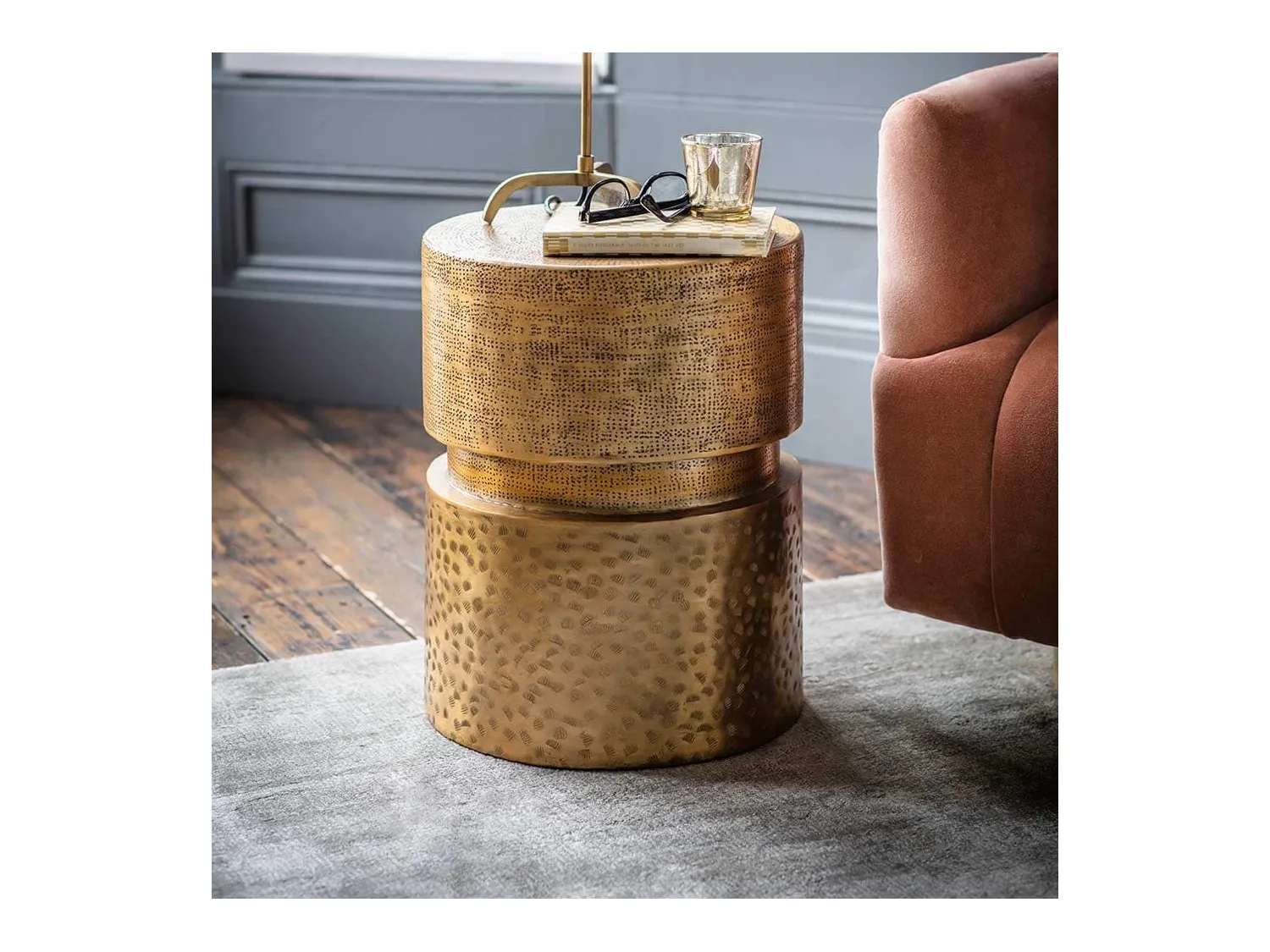 Round metal side table with antique brass finish