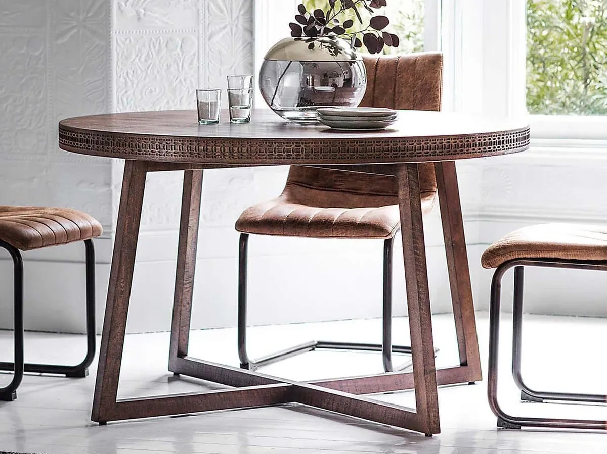 Round brown mango dining table with decorative carved edge