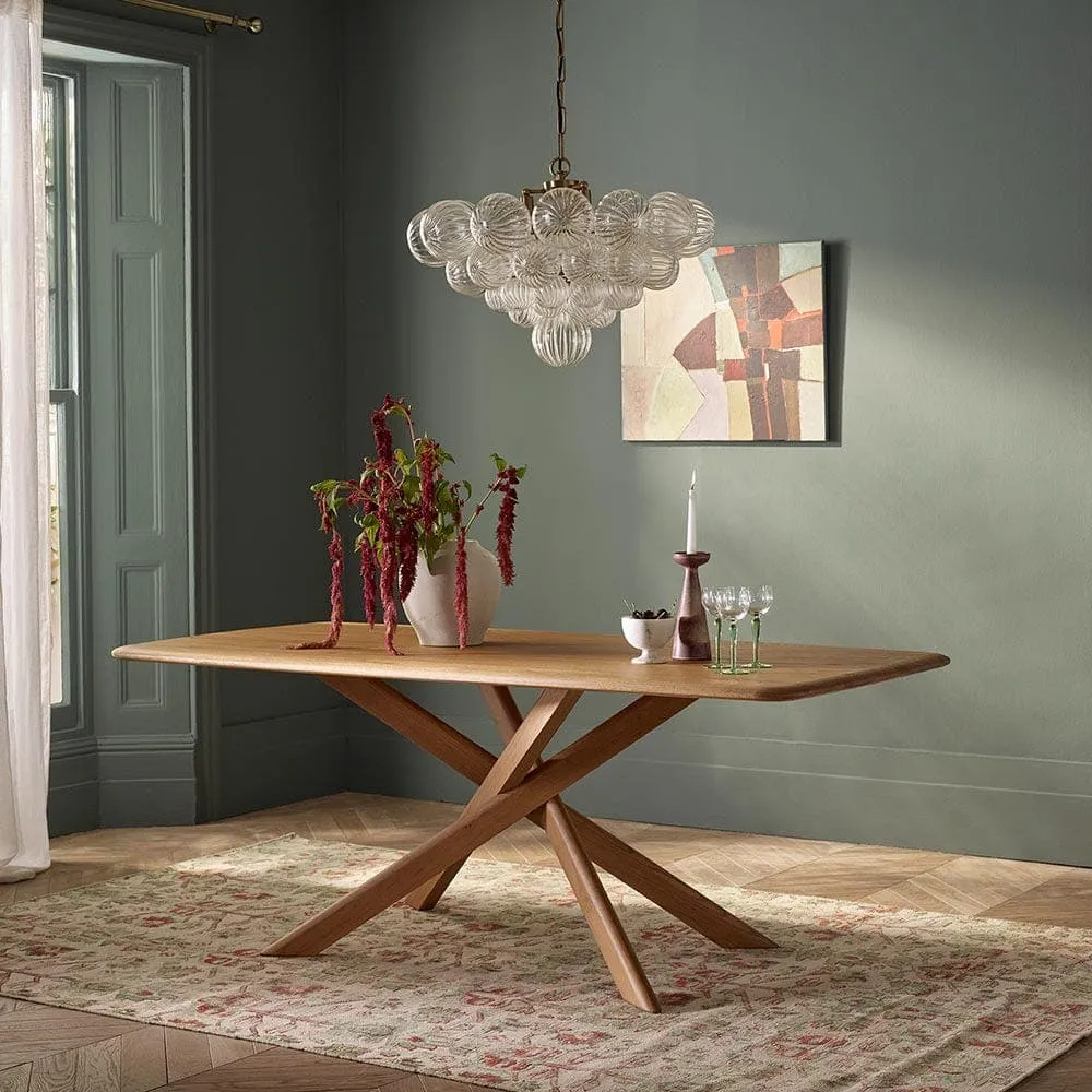 Oak dining table with sculptured base