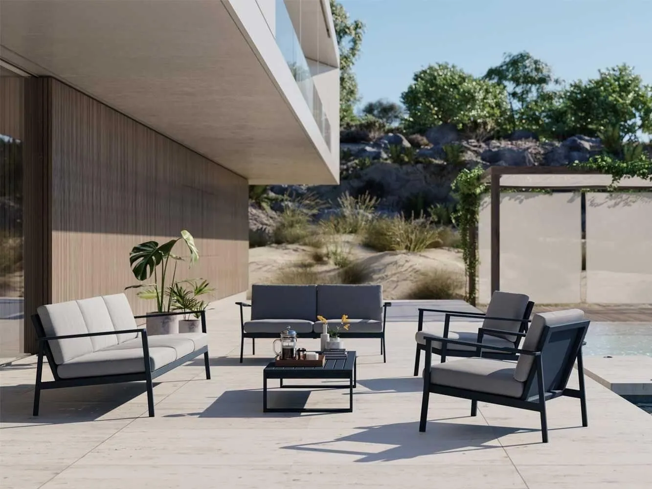 Black metal framed outdoor sofa set with matching table and grey cushions.