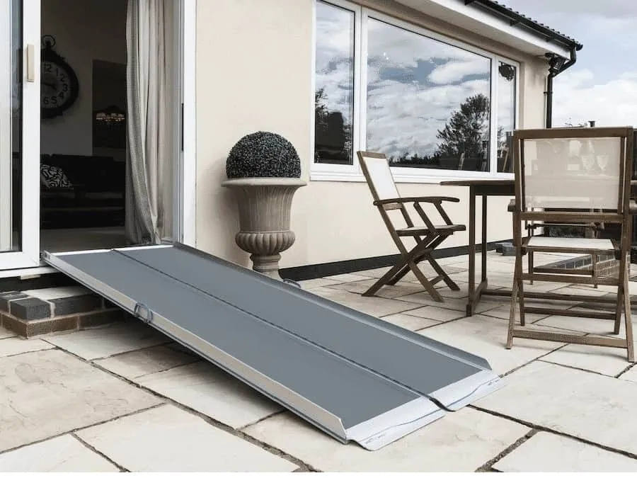 Folding wheelchair ramp giving access to patio doors