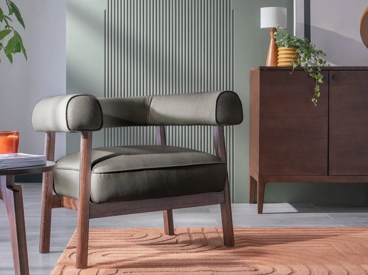 Grey fabric upholstered curve back chair with dark wood frame