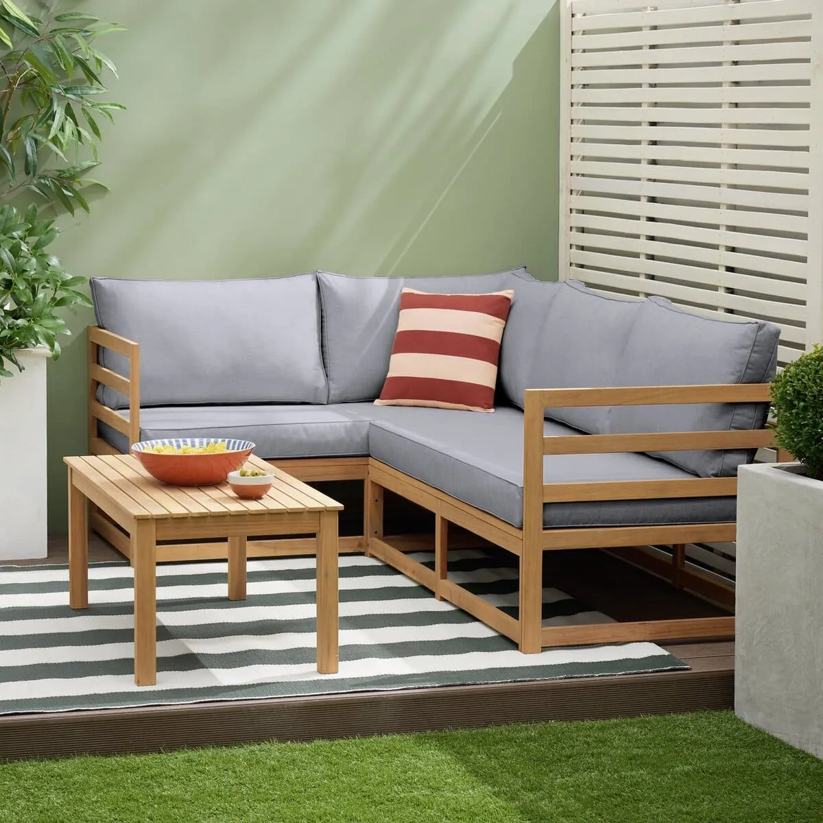 Outdoor corner sofa set with grey cushions and a wooden coffee table