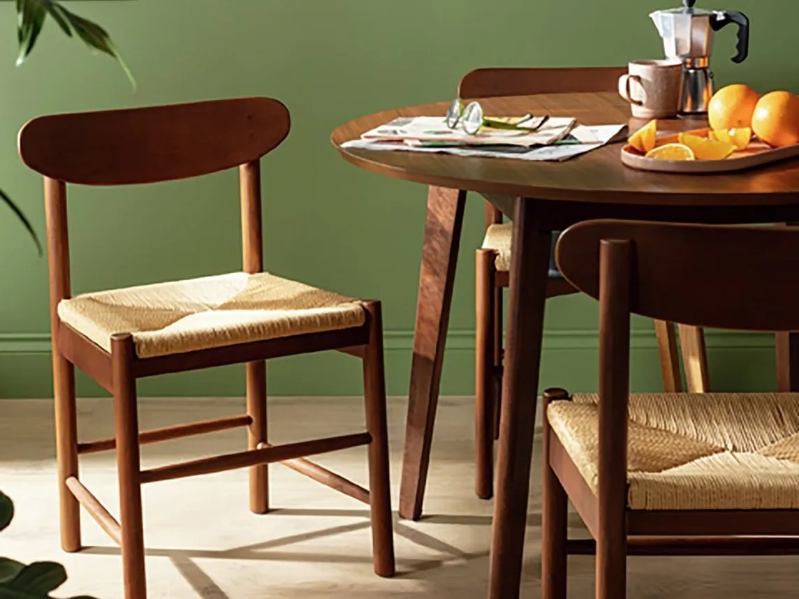 Walnut frame dining chair with woven seat pad