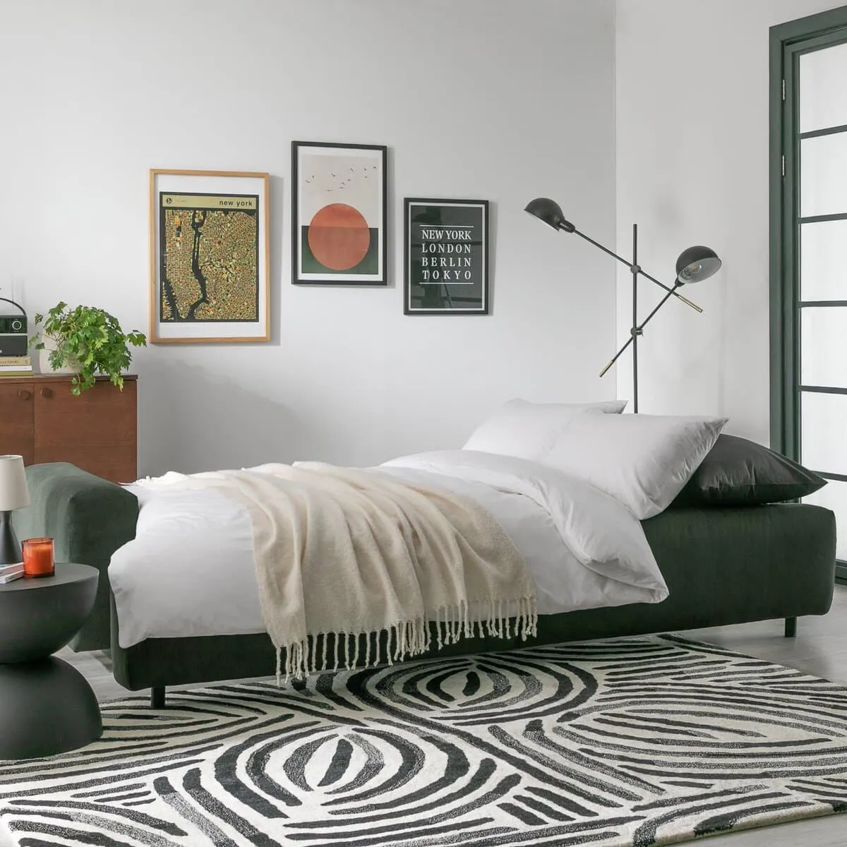 Green fabric sofa bed, made up as a bed
