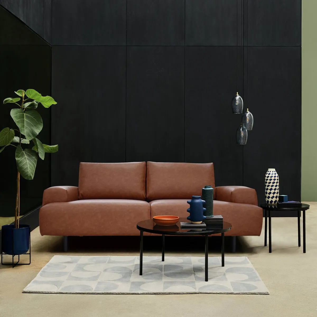 Chunky 2-seater sofa with tan coloured faux leather upholstery