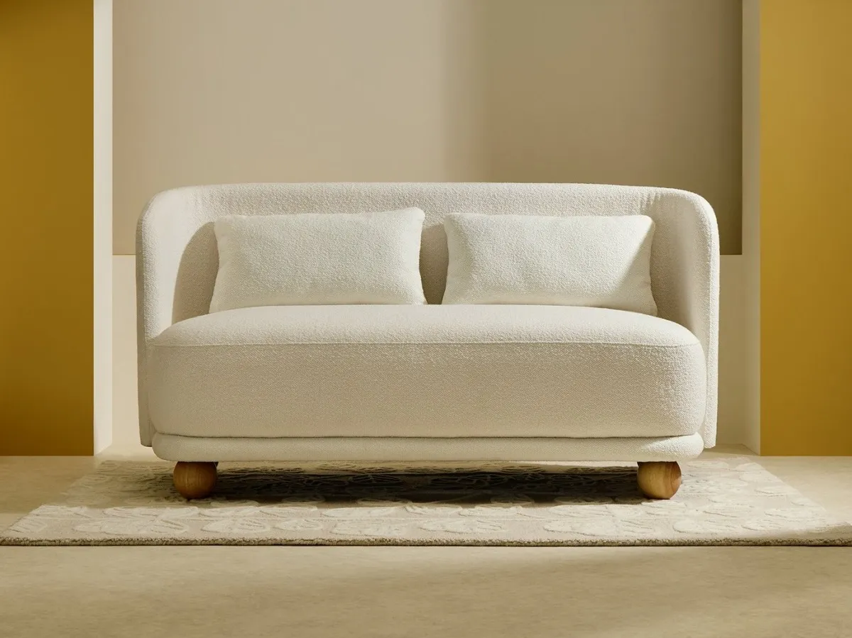 Curved, cream fabric sofa