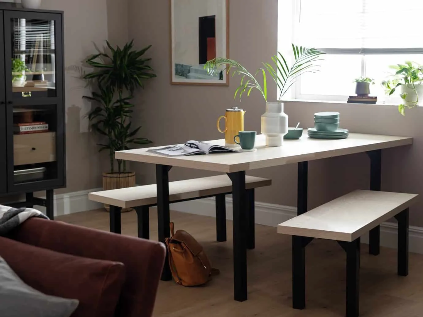 Black frame dining table with light oak finish top