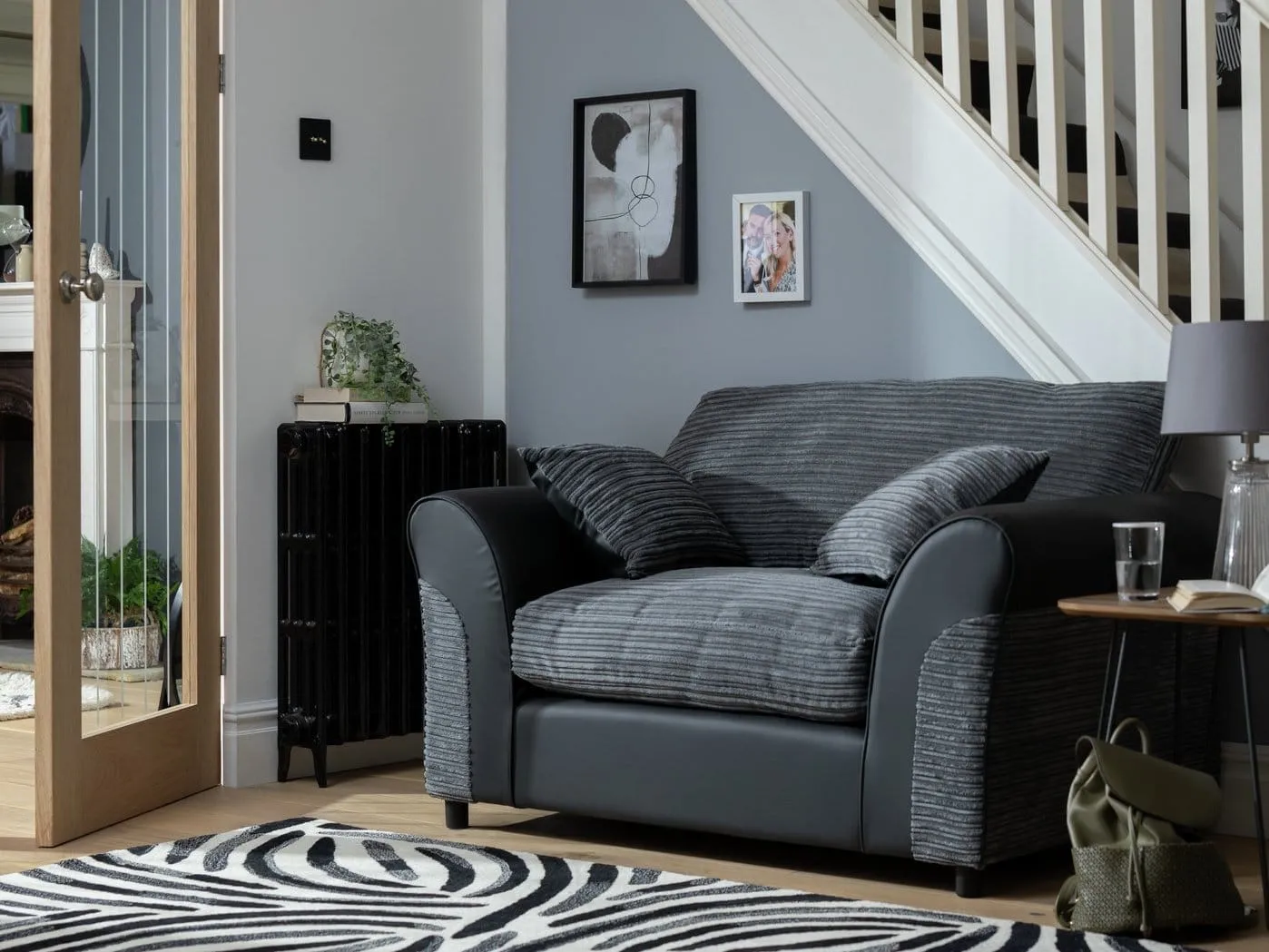 Grey corded fabric love seat armchair