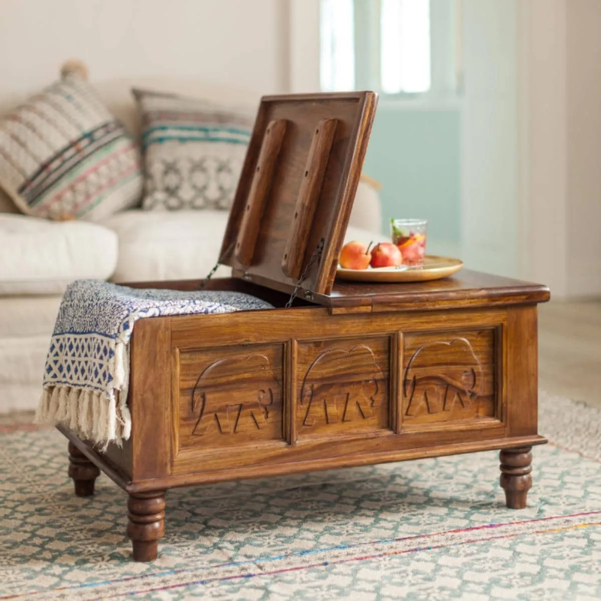 Sheesham storage coffee table with carved elephant motifs