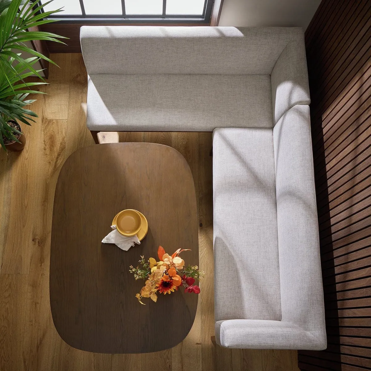 Walnut dining table and grey fabric corner bench