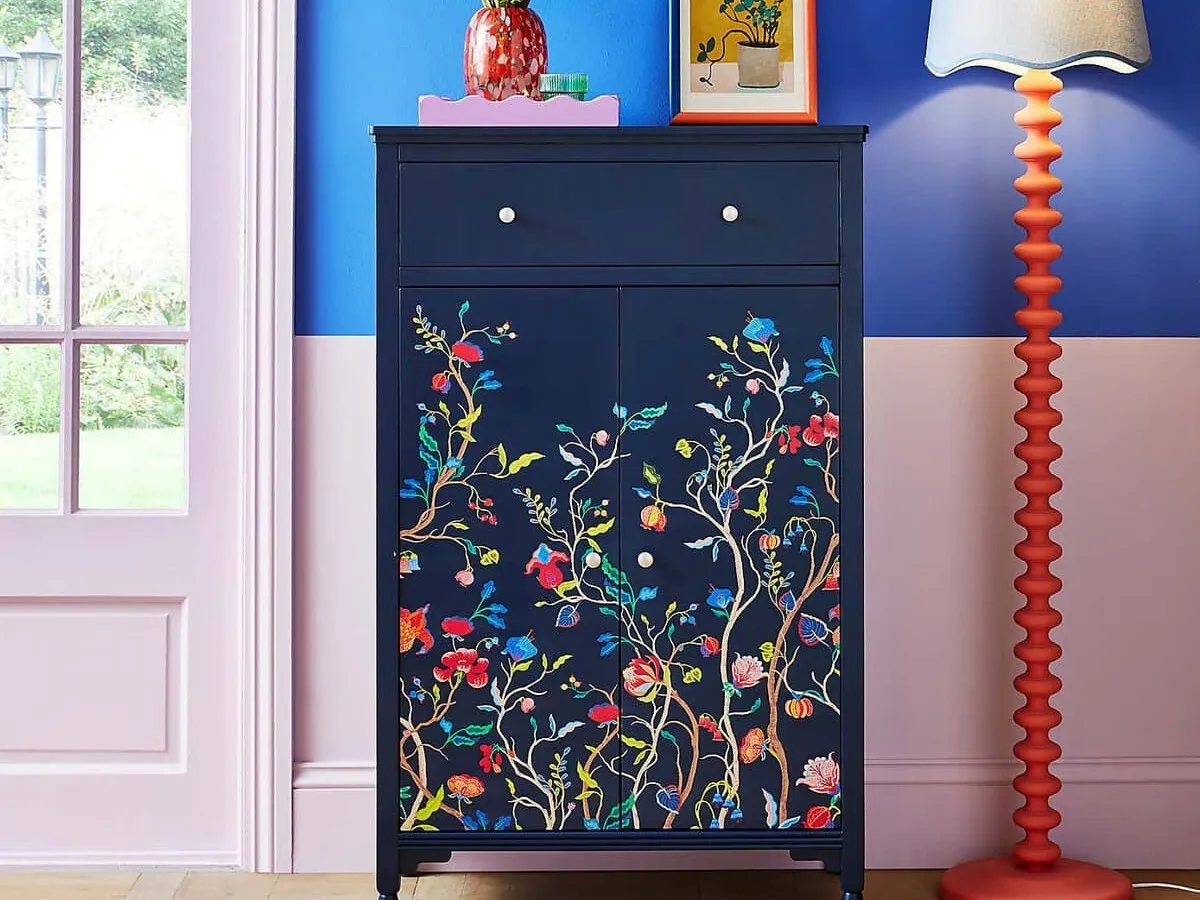 Navy hallway cupboard with floral decoration