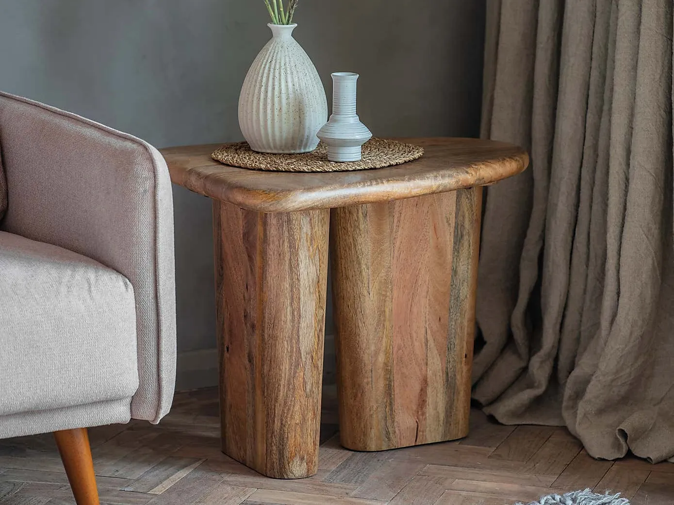 Solid curved form mango side table