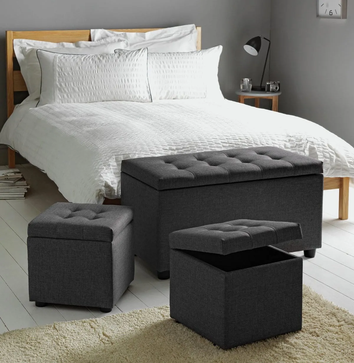 Grey fabric ottoman with a pair of matching storage stools