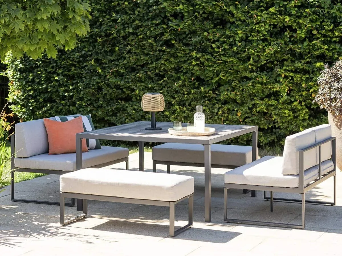 Outdoor square metal table with a pair of sofas and benches