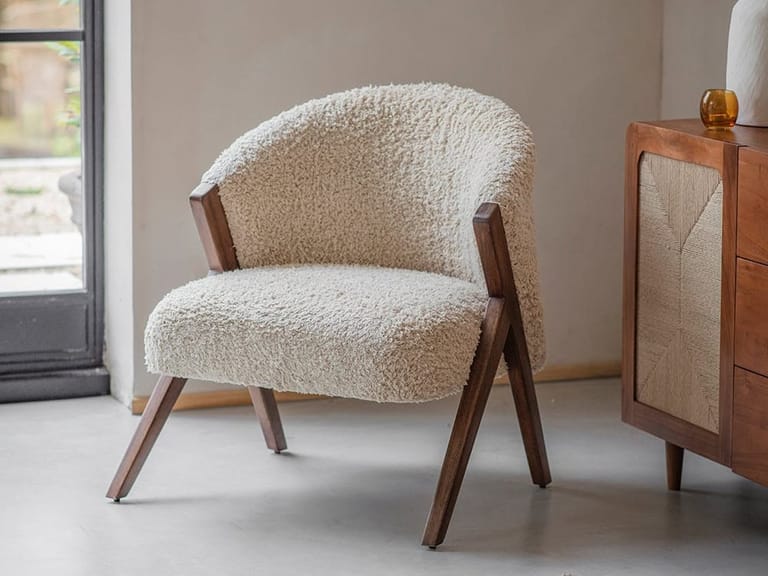 White boucle chair with dark wood frame