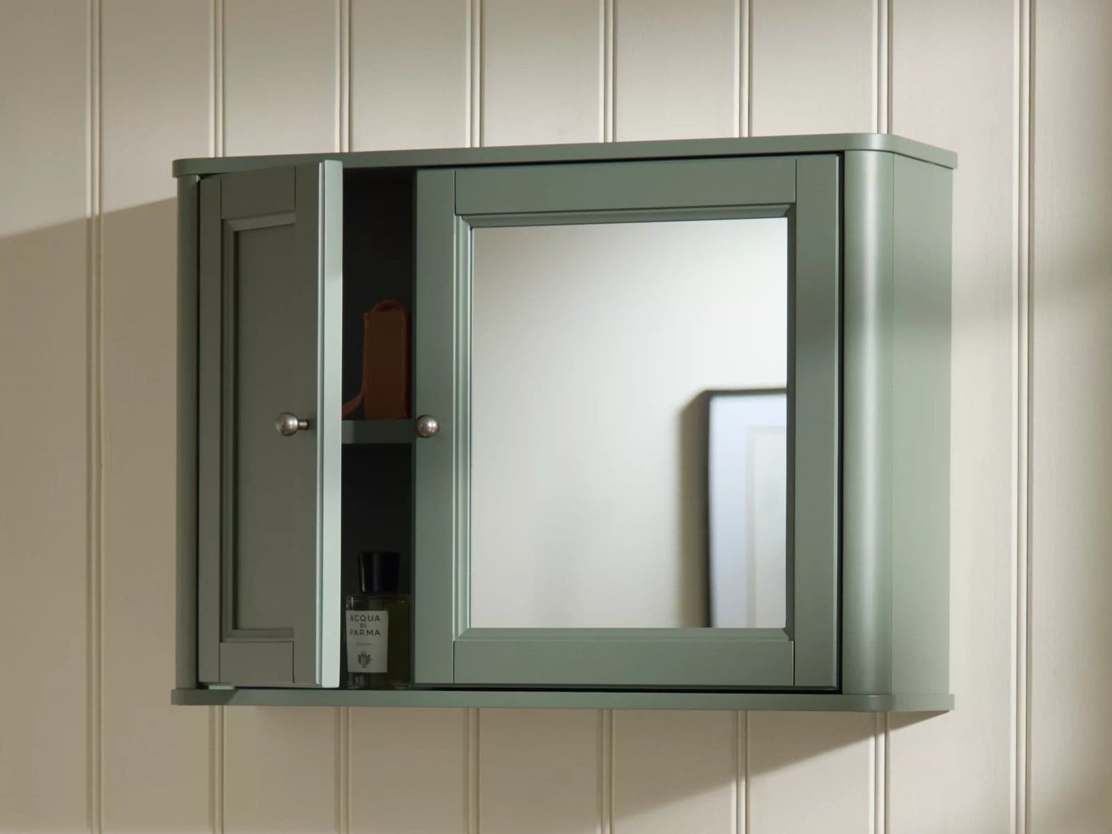Green-painted bathroom cabinet with mirror doors