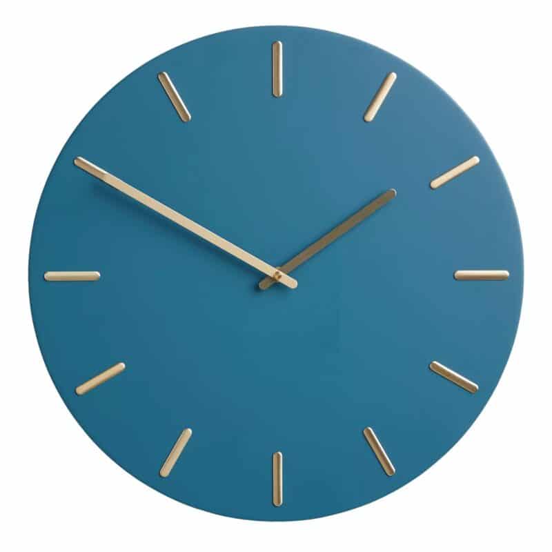 Blue wall clock with brass numerals and hands