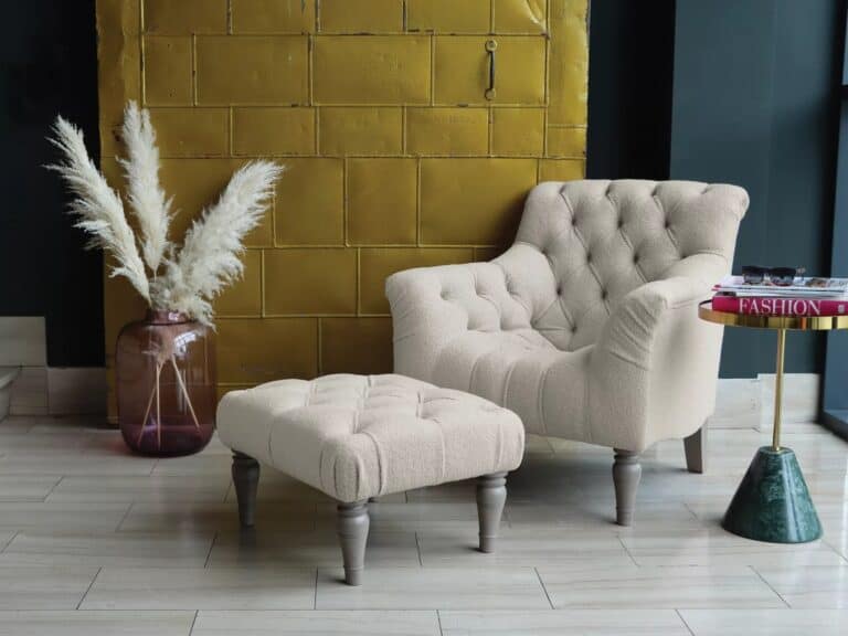 Beige fabric armchair and matching footstool