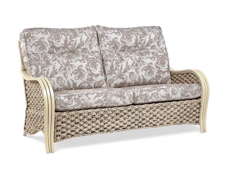 Cane and rattan sofa with floral fabric cushions