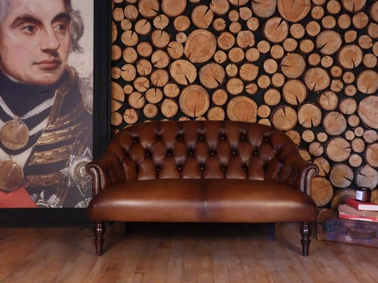 Leather upholstered button back sofa with turned wooden legs