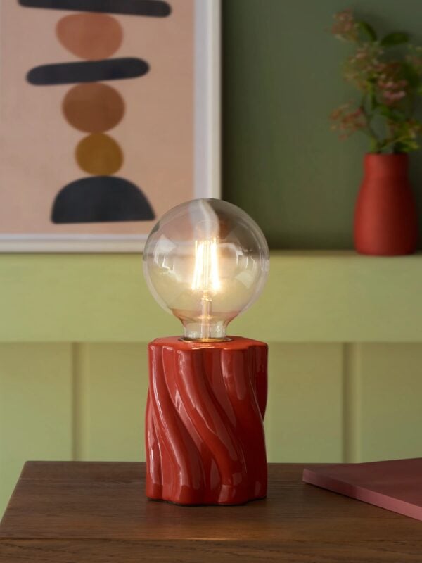 Red table lamp with twisted-effect base