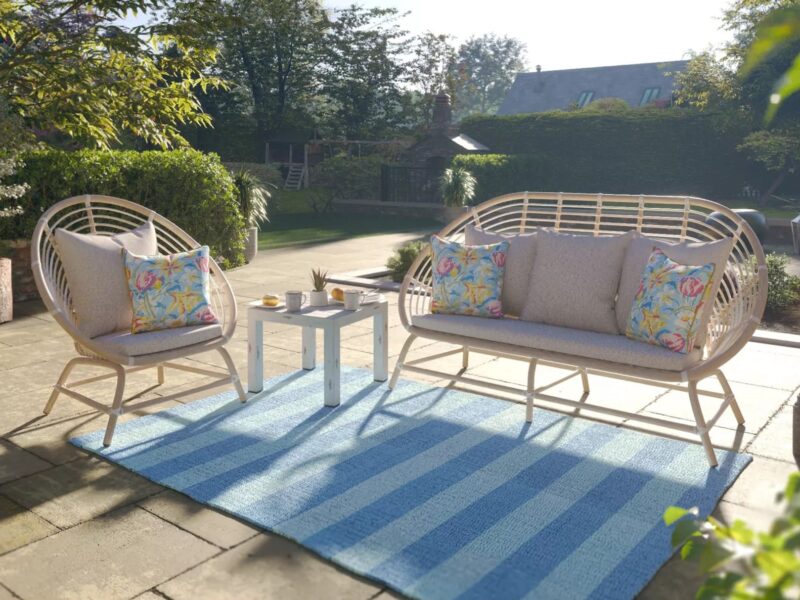 Woven rattan garden sofa, matching chair and a side table