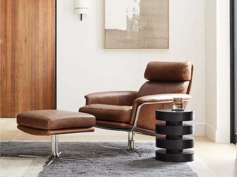 Brown leather swivel armchair and matching footstool