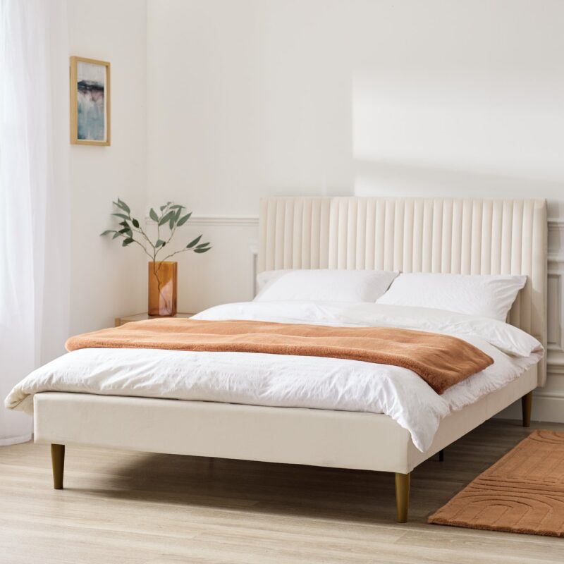 Natural velvet upholstered bed frame with large vertical panel headboard and tapered wooden legs