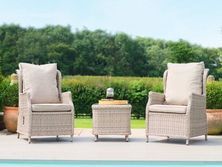 Pair of reclining rattan armchairs and a matching side table