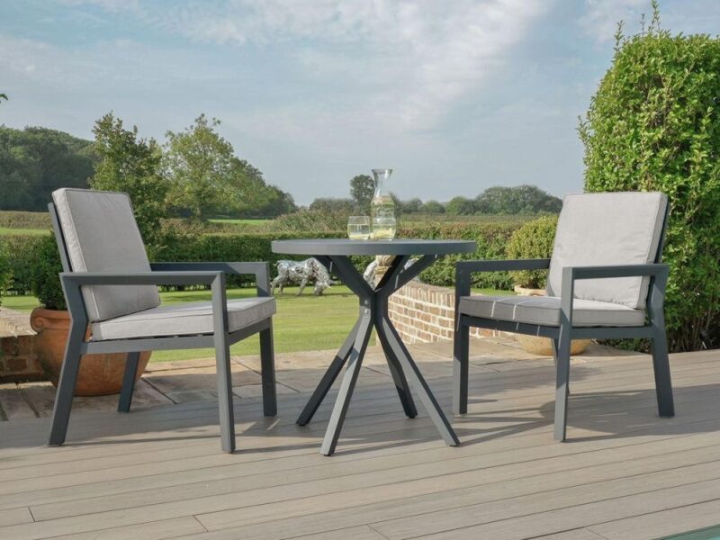 Pair of grey metal garden chairs with grey cushions and a round bistro table