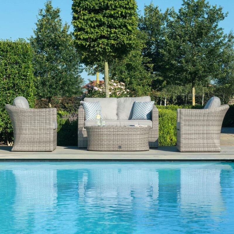 Rattan outdoor sofa, a pair of rattan armchairs and an oval coffee table