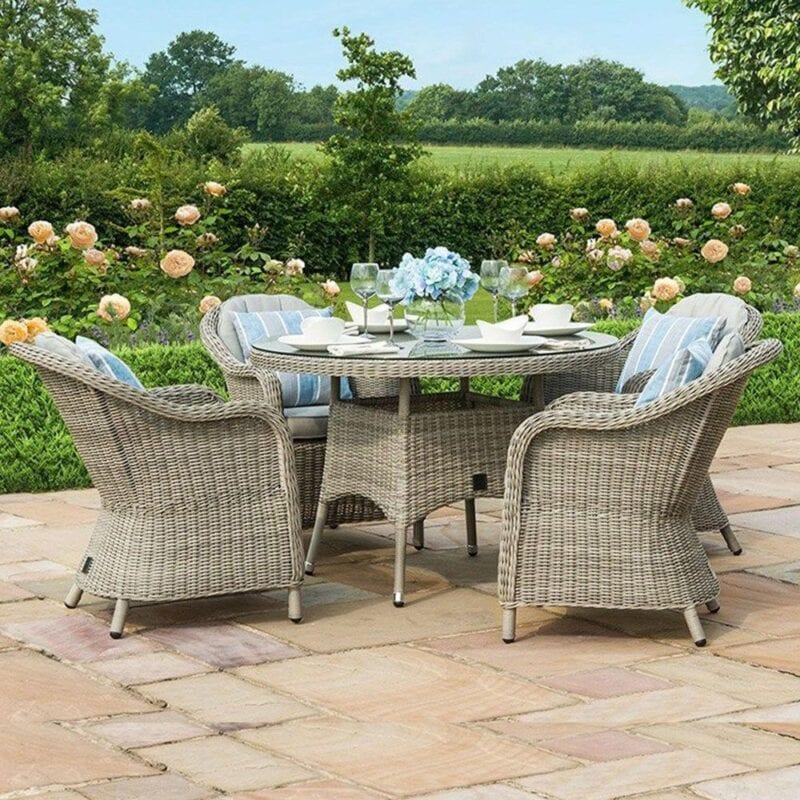 Round rattan outdoor dining table and 4 rattan armchairs