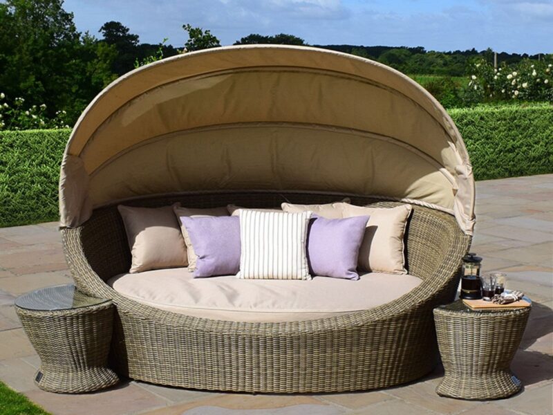 Rattan day bed with canopy and two round side tables