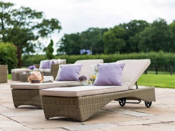 Pair of rattan sun loungers with cushions